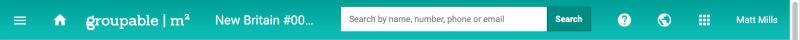 The top bar with the menu icon, house icon, M2 logo, search box, question mark, globe, grid of squares, and the name of the logged-in user.